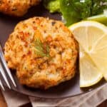 Overhead image of fish cakes on a plate with lemon and broccoli - 8