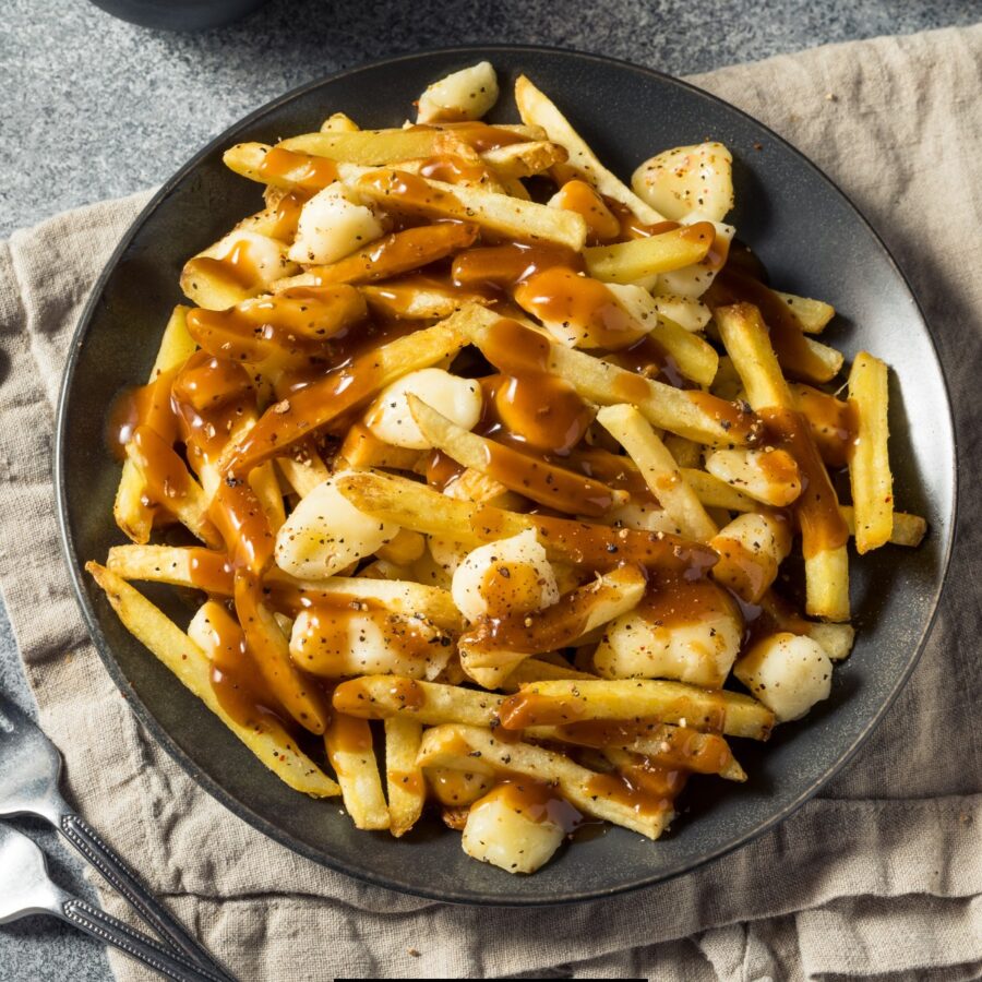 Overhead image of homemade poutine on a black plate