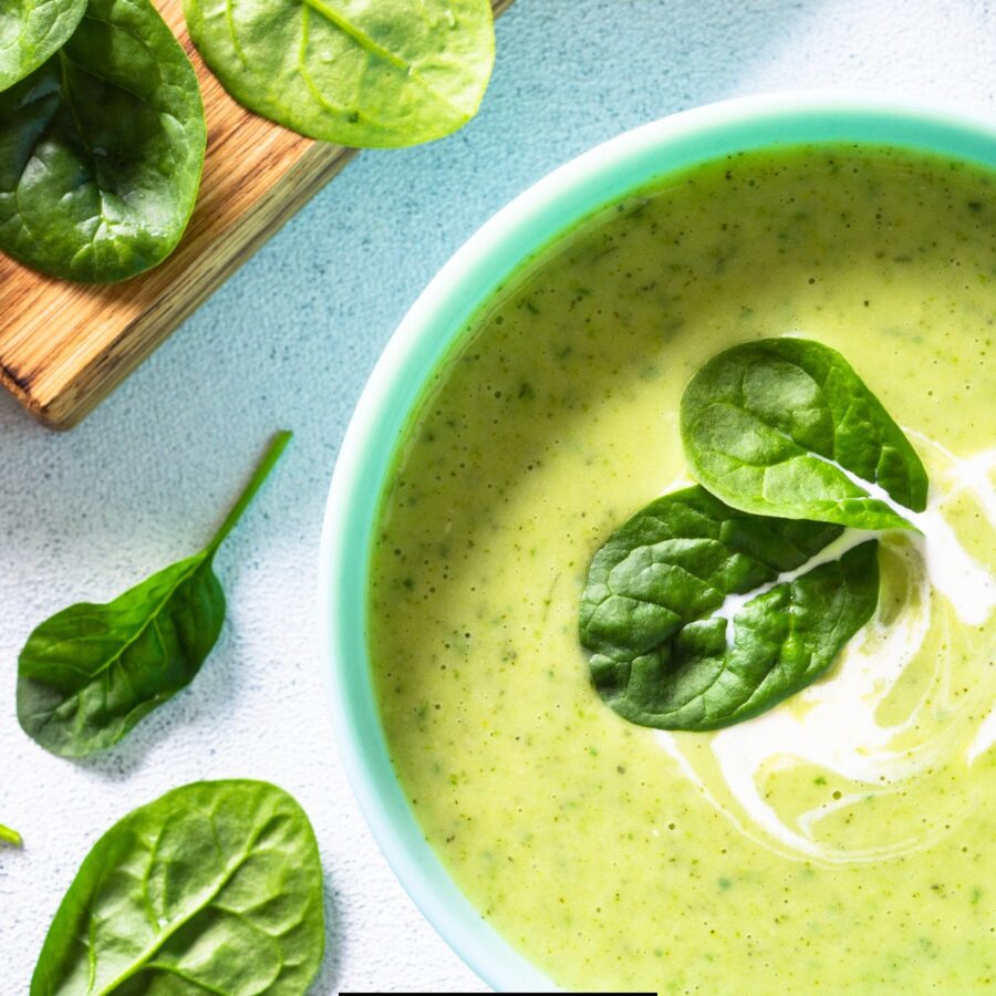 Close up image of Spinach Soup with chopped spinach next to it