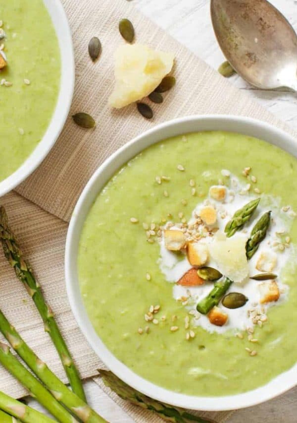 Overhead image of two bowls of asparagus soup