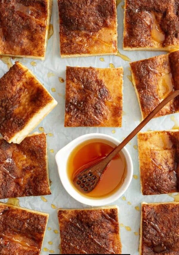 Overhead image of Cheesecake Bars with a bowl of honey in the middle