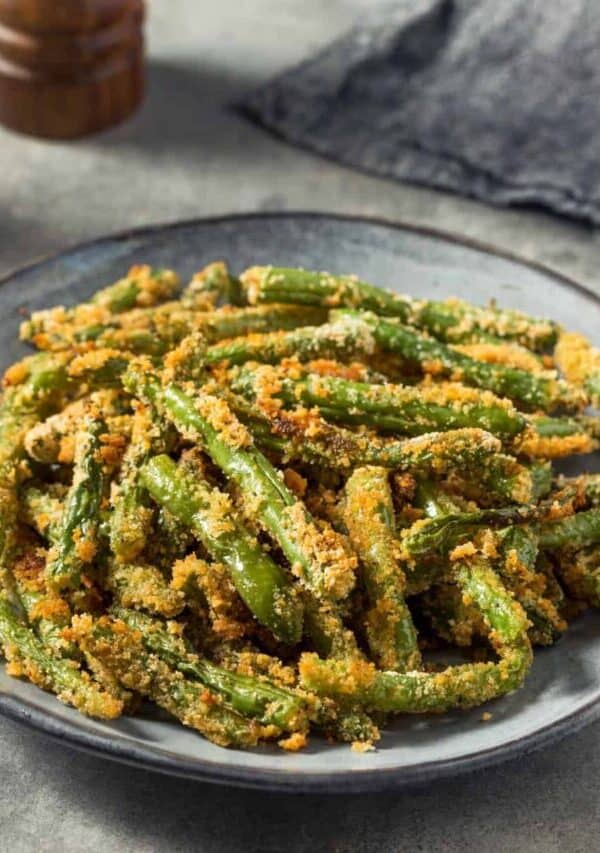 Several servings of crispy green beans in a slate colored bowl