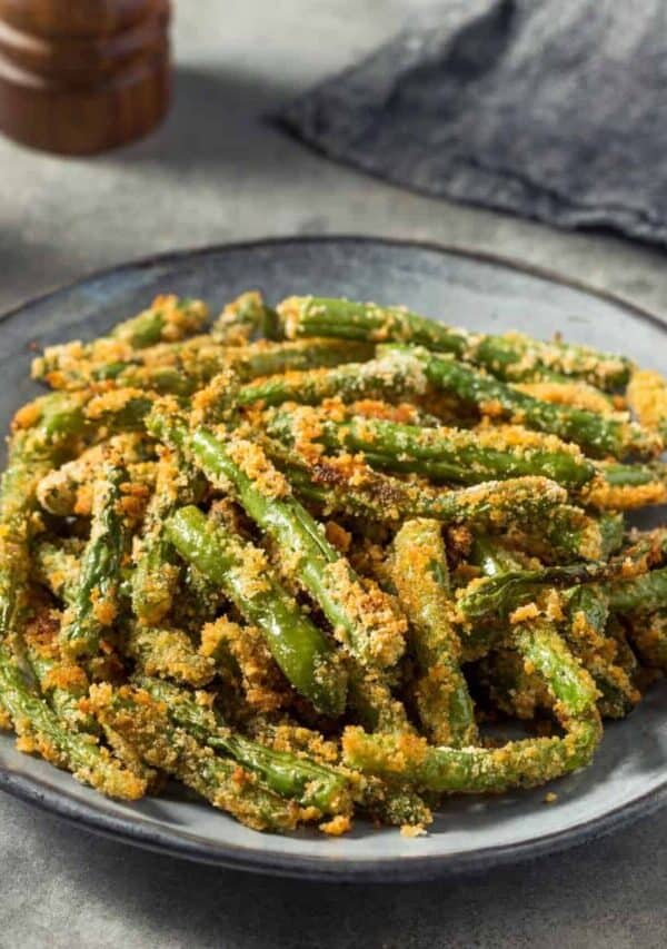 Several servings of crispy green beans in a slate colored bowl