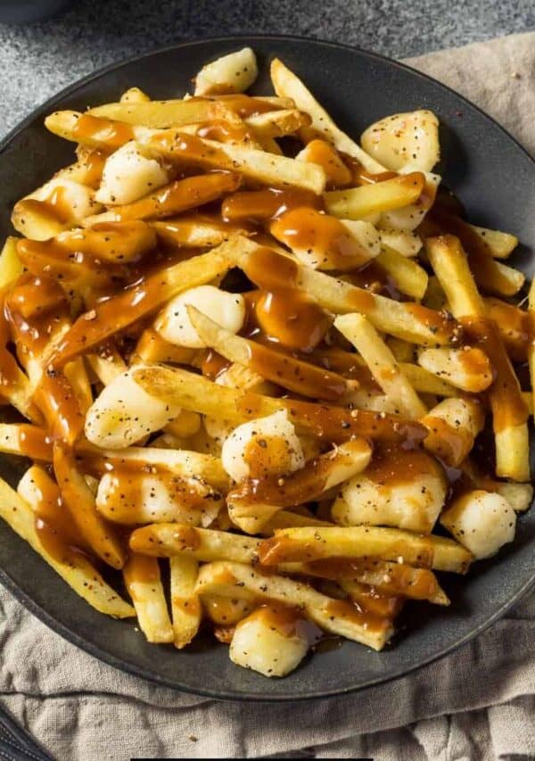 Overhead image of homemade poutine on a black plate