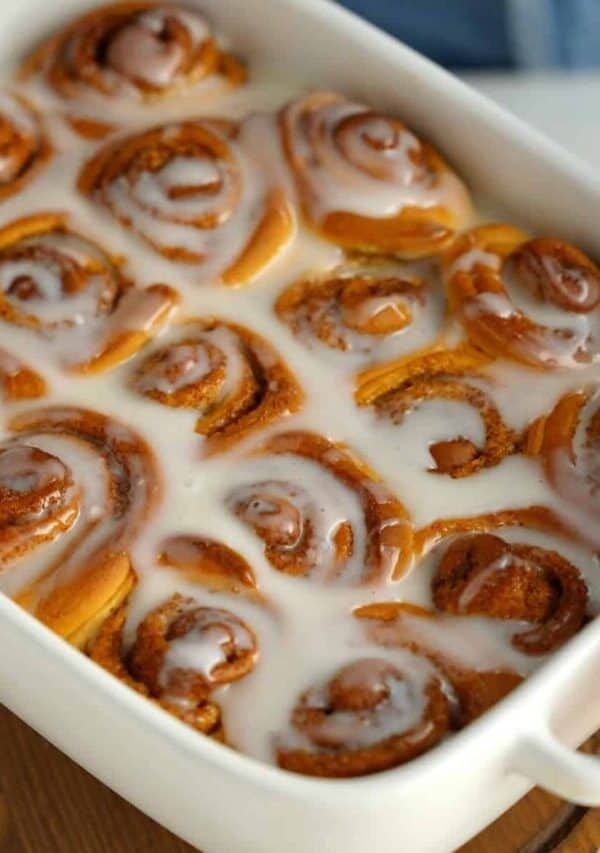Orange Rolls with glaze in a white baking dish