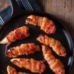 Close up image of Bacon Wrapped Chicken Tenders in a skillet - 9
