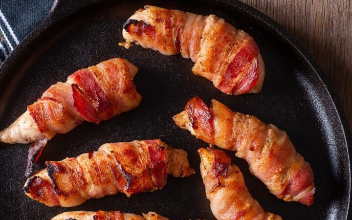 Close up image of Bacon Wrapped Chicken Tenders in a skillet