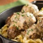 Close up image of crock pot swedish meatballs on egg noodles in a bowl - 8