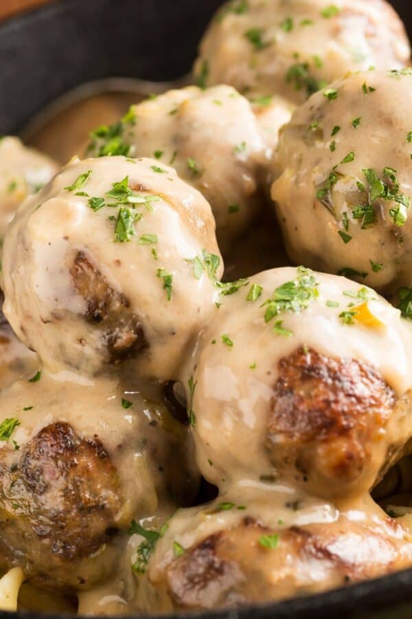 Overhead image of Crockpot Swedish Meatballs in a bowl with egg noodles