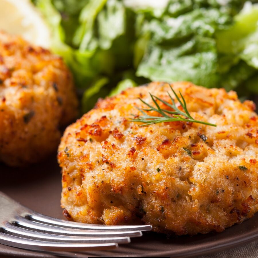 Close up image of Fish Cakes on a plate with salad