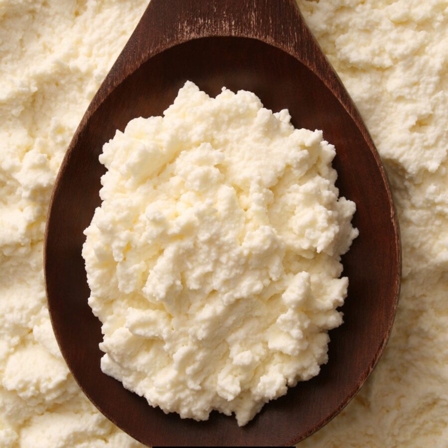 Homemade Ricotta Cheese on a wooden spoon