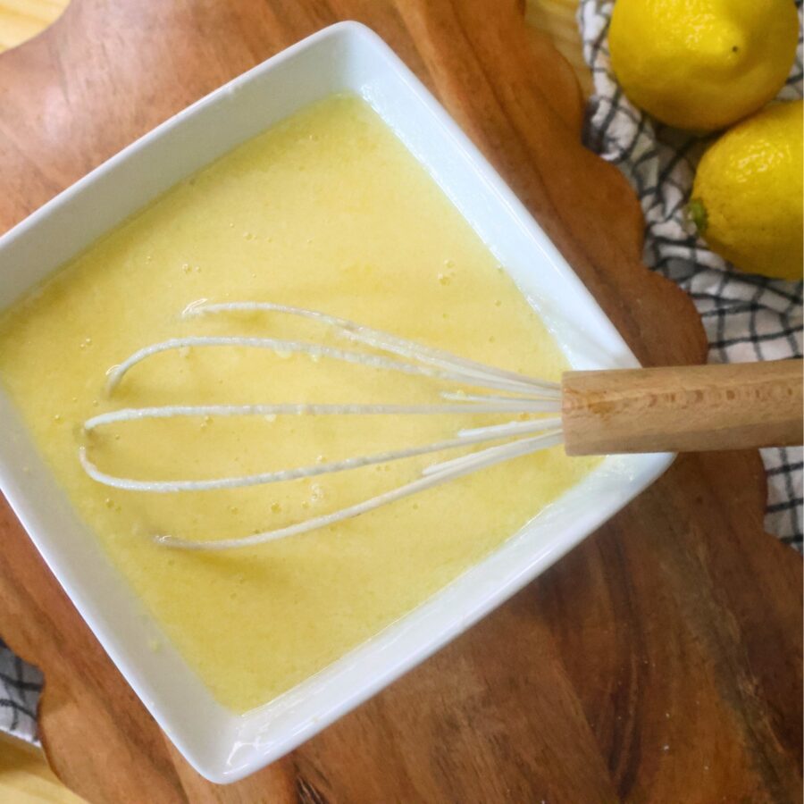 Wet ingredients for lemon muffins in a square bowl