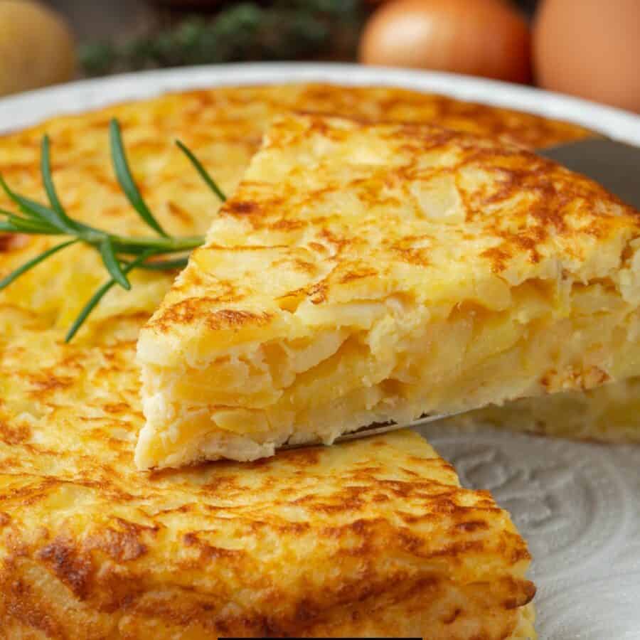 Close up image of a Potato Frittata with a slice cut out of it