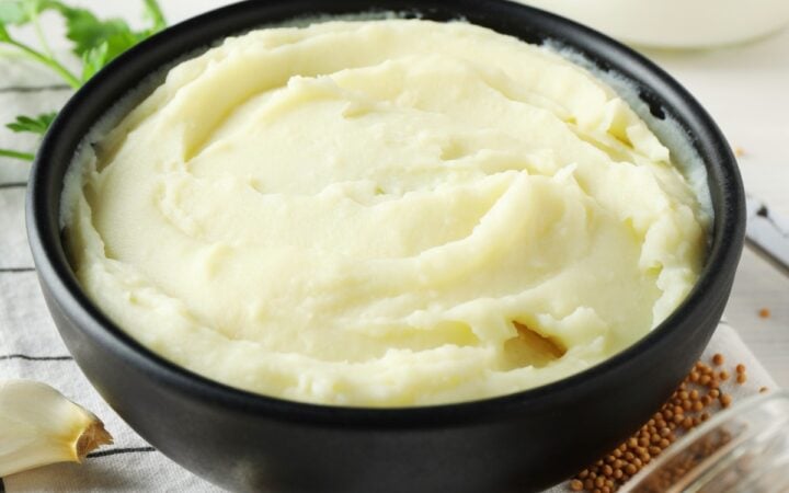 Sour Cream Mashed Potatoes in a black bowl