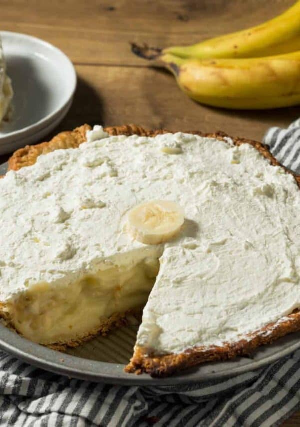 Overhead image of Banana Cream Pie with a slice on a plate next to it
