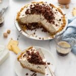 A cannoli pie with a slice taken out and plated next to it - 7