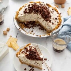 A cannoli pie with a slice taken out and plated next to it
