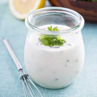 Healthy Ranch in a glass jar with a whisk next to it