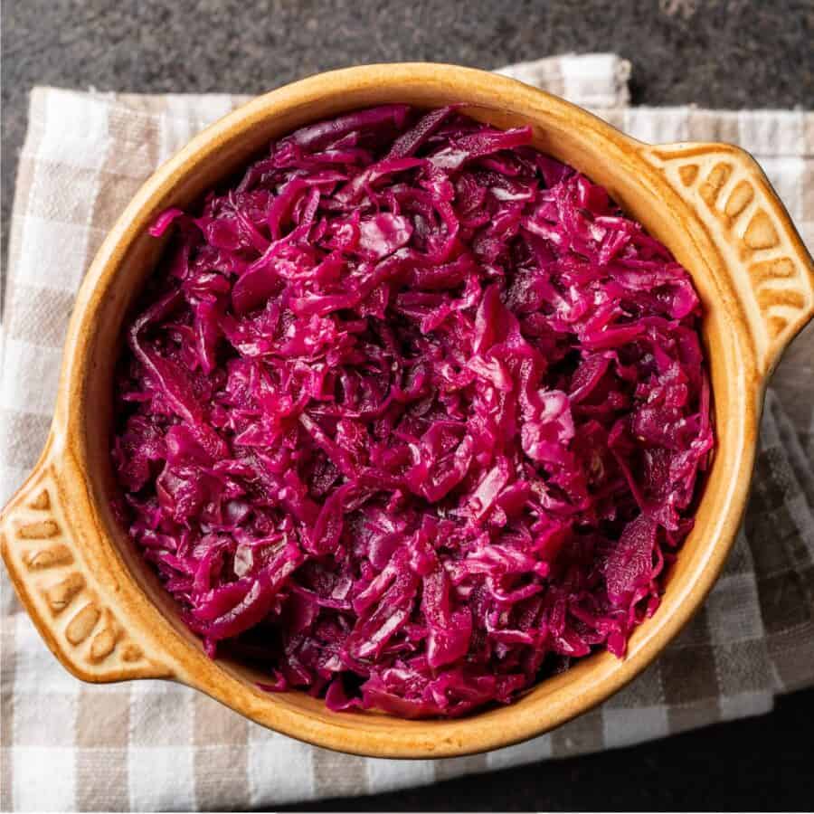 Overhead image of pickled cabbage in a yellow ceramic bowl