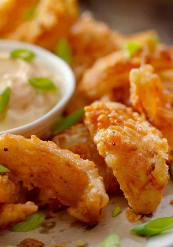 Close up image of air fryer onion petals on a plate