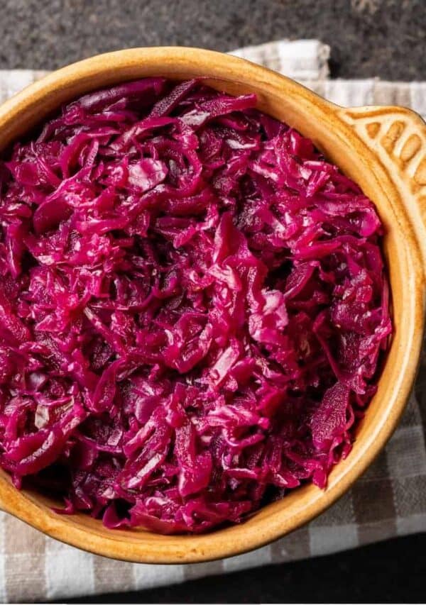 Overhead image of pickled cabbage in a yellow ceramic bowl