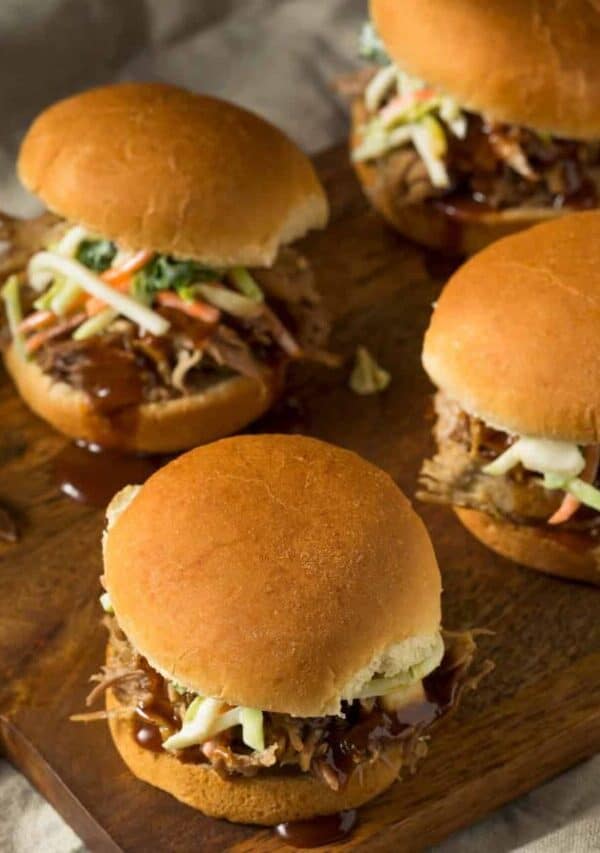 Close up image of Pulled Pork Sliders on a wooden cutting board