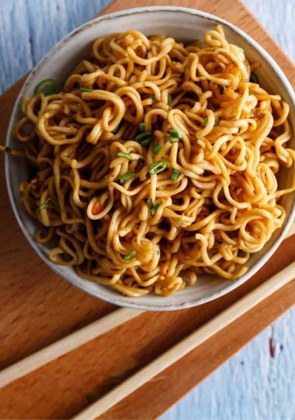 Teriyaki Noodles in a bowl with a sauce bowl next to it