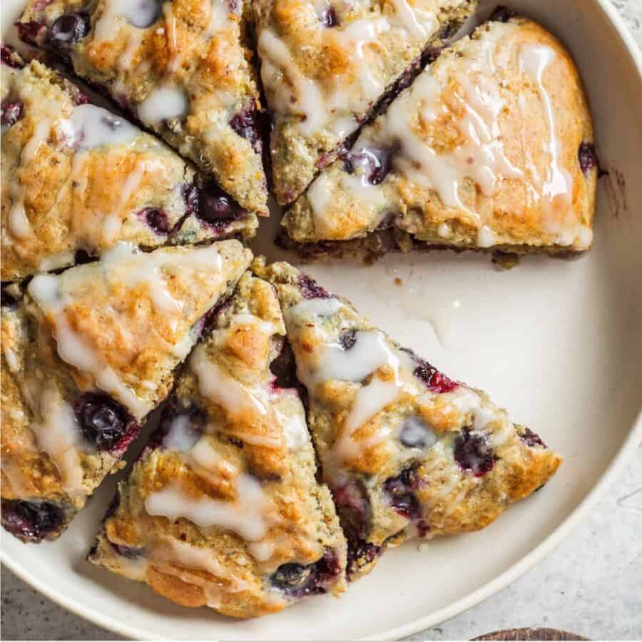 Overhead image of blueberry scones on a white serving platter