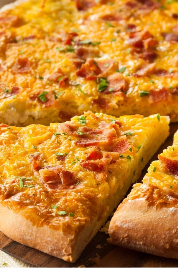 Close up image of a slice cut out of a Breakfast Pizza