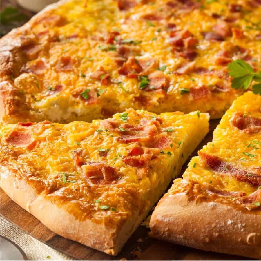 Close up image of a slice cut out of a Breakfast Pizza