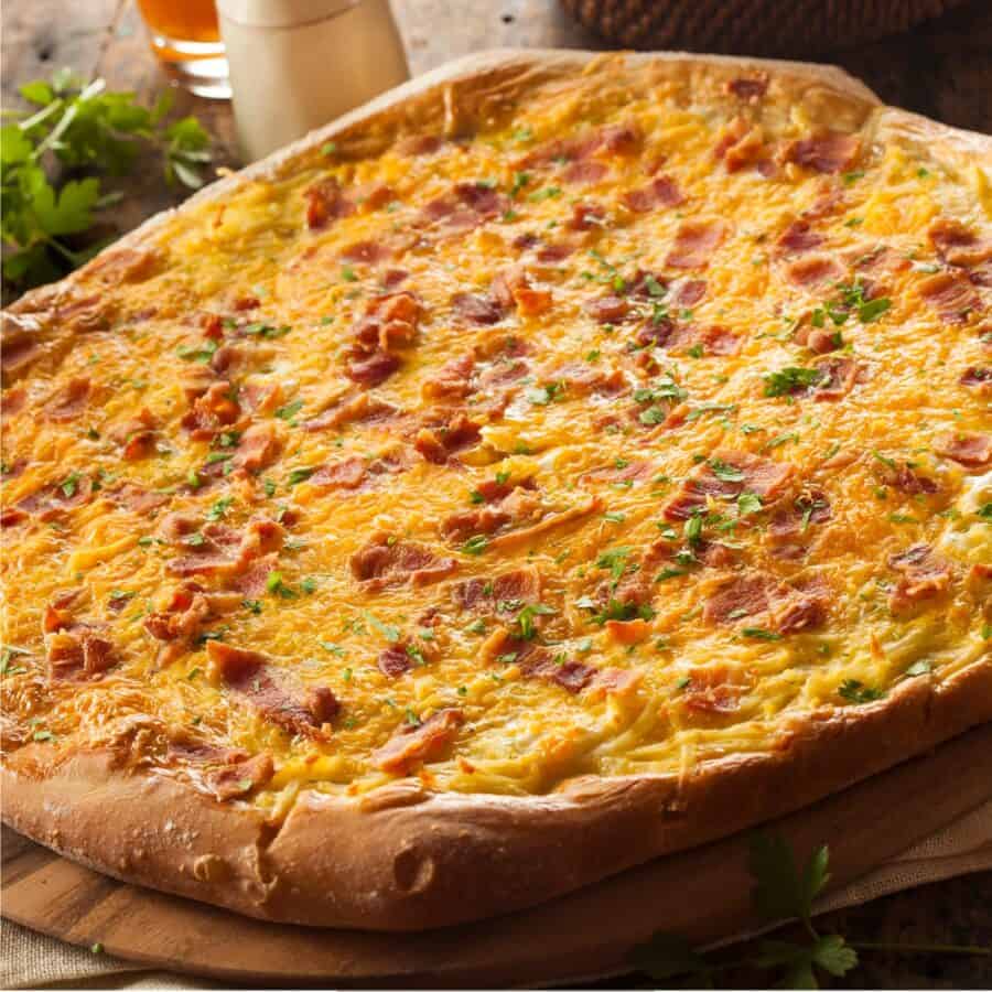 Bacon Egg and Cheese Breakfast Pizza on a wooden surface