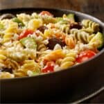 Close up image of Greek Pasta Salad in a black bowl - 8
