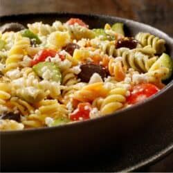 Close up image of Greek Pasta Salad in a black bowl