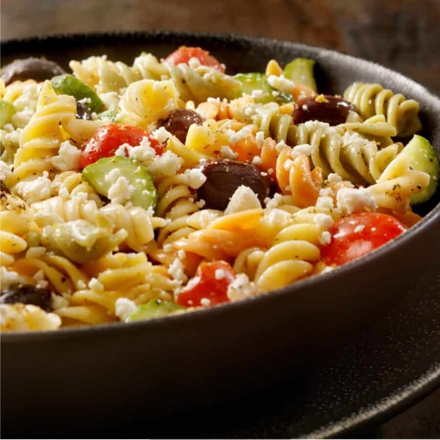 Close up image of Greek Pasta Salad in a black bowl