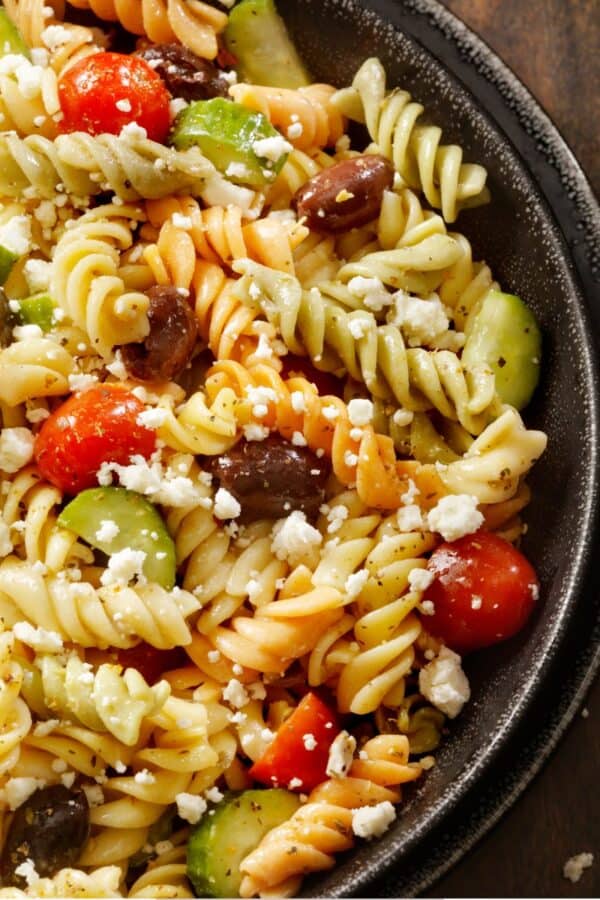 Overhead image of Greek Pasta Salad in a black bowl