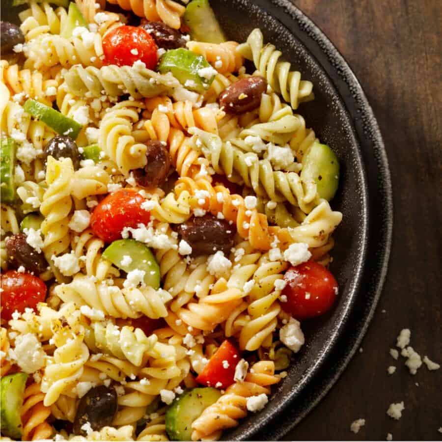 Overhead image of Greek Pasta Salad in a black bowl