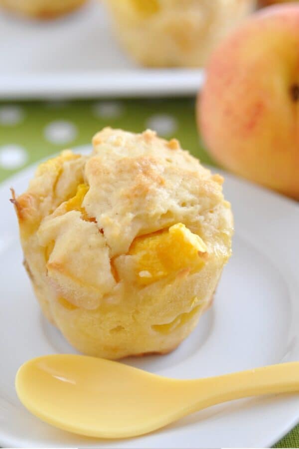Close up image of peach muffins on a white plate