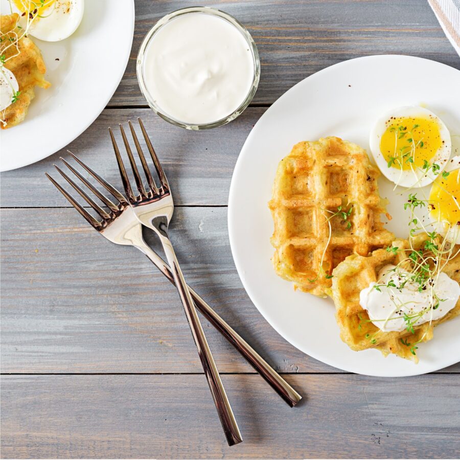 Overhead image of Potato Waffles on a white plate with eggs
