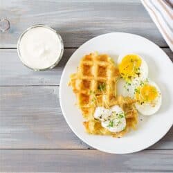 Close up image of Potato Waffles with over easy eggs