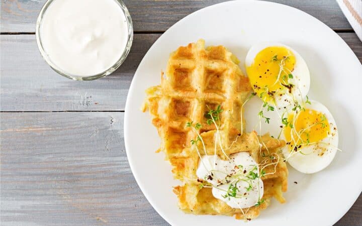 Close up image of Potato Waffles with over easy eggs