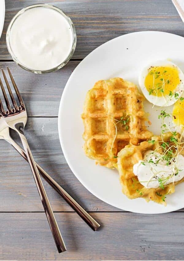 Overhead image of Potato Waffles on a white plate with eggs