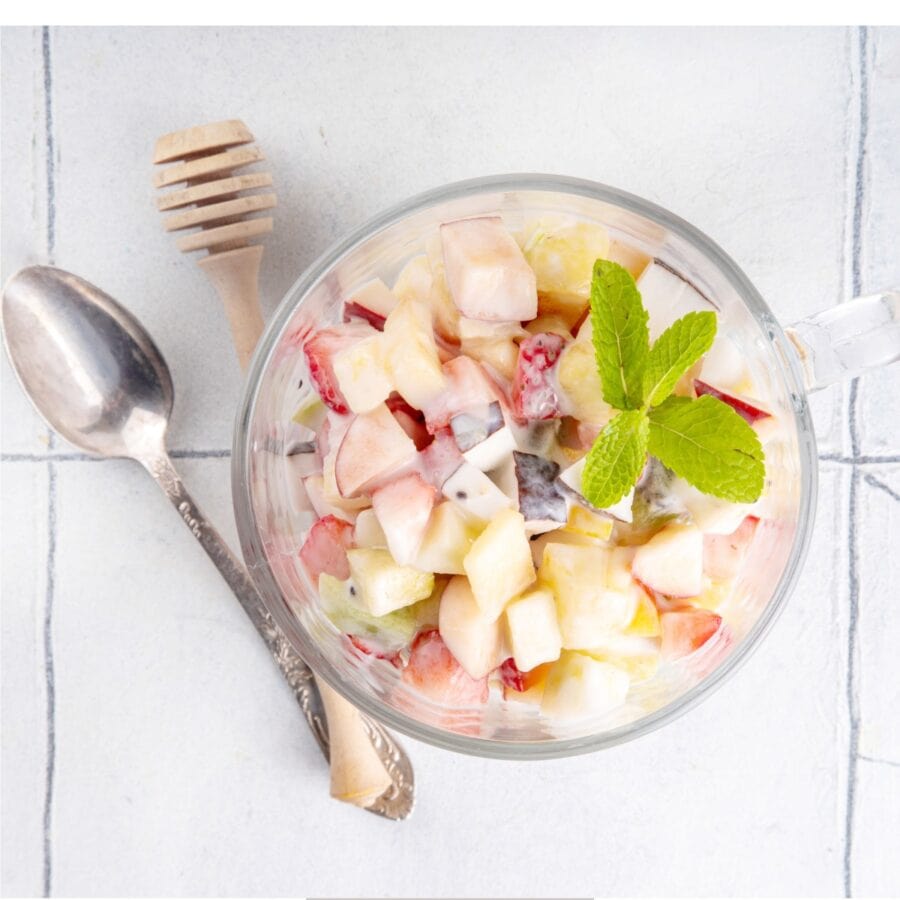 Overhead image of Cheesecake Fruit Salad in a glass mug
