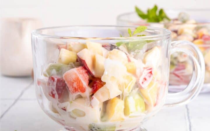 Close up image of Cheesecake Fruit Salad in a glass mug