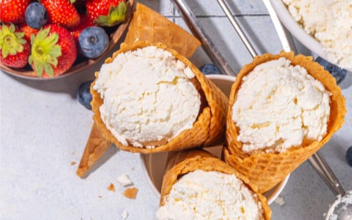 Overhead image of three Cottage Cheese Ice Cream Cones with a bowl of fruit