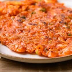 Close up image of Kimchi Pancakes on a tan plate