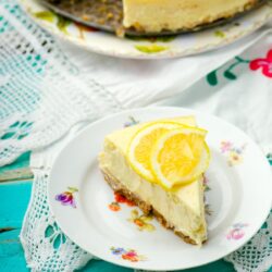 A slice of lemon cheesecake on a decorative plate