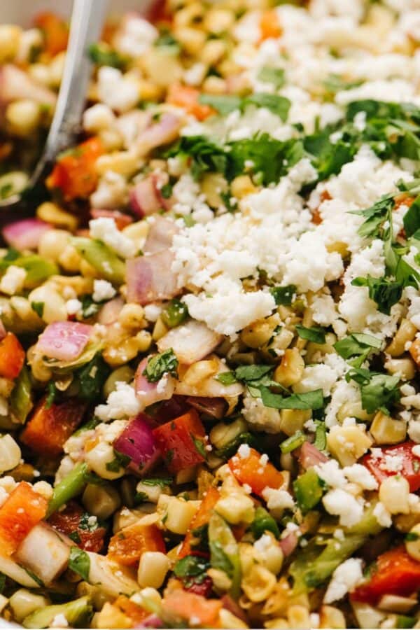 Close up image of Mexican Street Corn Salad in a white bowl