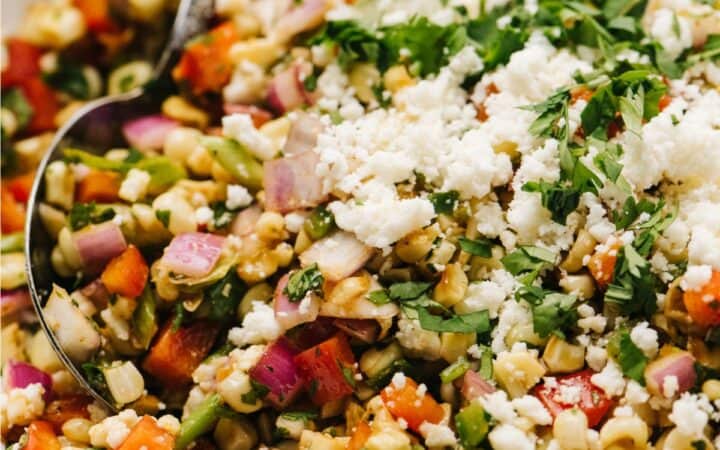 Close up image of Mexican Street Corn Salad in a white bowl