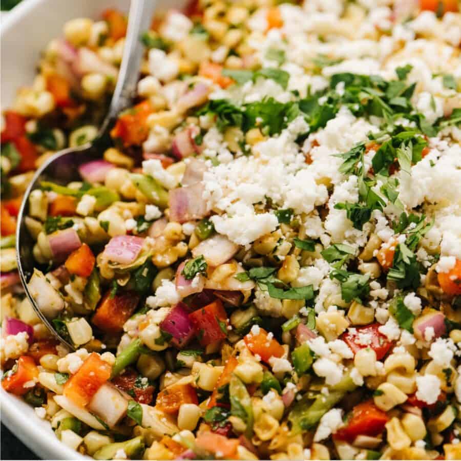 Close up image of Mexican Street Corn Salad in a white bowl
