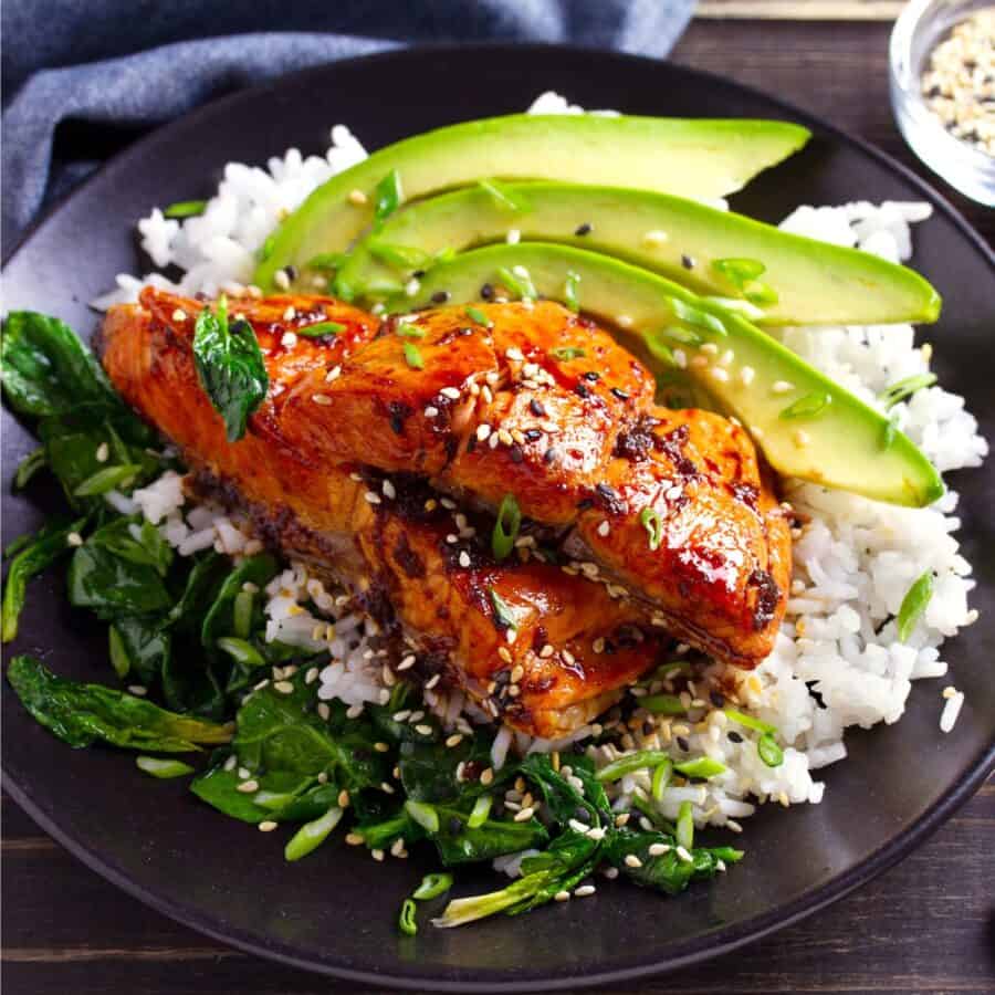 Sweet Chili Salmon on a plate with rice and veggies